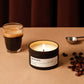 Candle labeled 'Roasted Coffee' with a glass of coffee and coffee beans on a brown surface