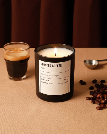 Roasted coffee candle with a glass of coffee on a brown surface