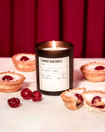 Cherry Bakewell candle with tartlets and cherries on a red background