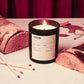 Fireside candle with matches on a surface with a red curtain background