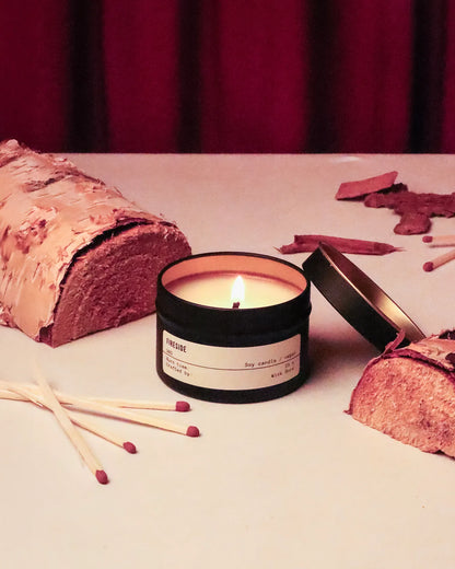 Candle with matches and a wooden log on a surface