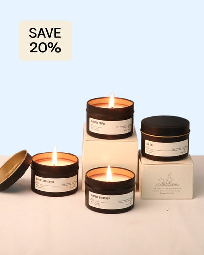 Set of candles with packaging on a light blue background, featuring a 'Save 20%' label.