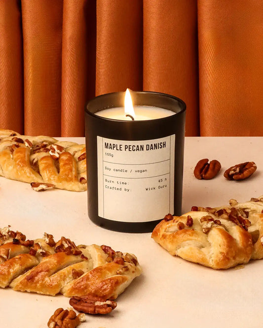 Maple pecan danish candle with pastries and nuts on a table