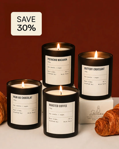 four lit candles with labels on a white surface, with a 'Save 30%' sign above.
