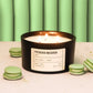 Pistachio macaron candle with green macarons on a light background
