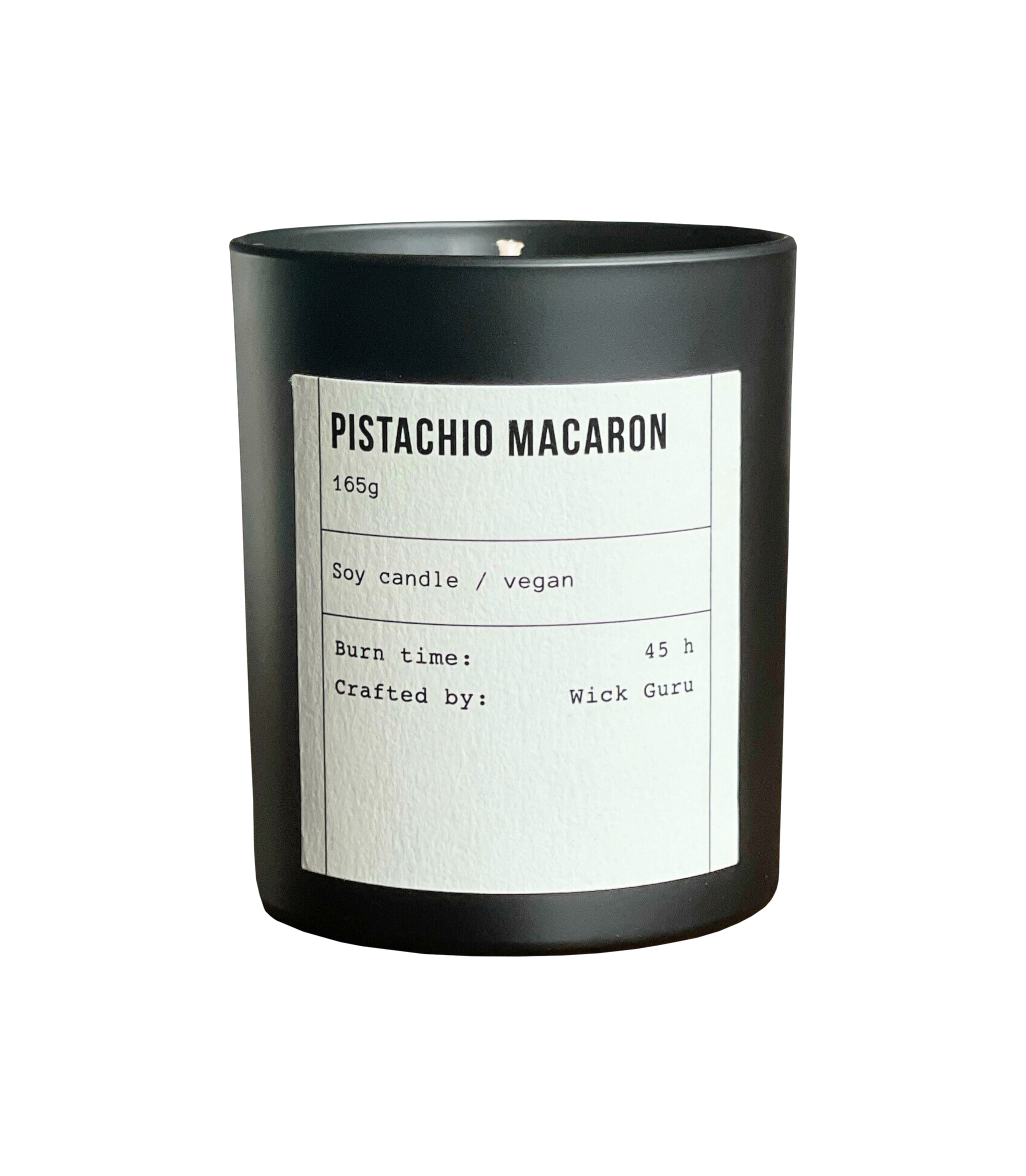 Candle labeled 'Pistachio Macaron' with black container and white label on a white background