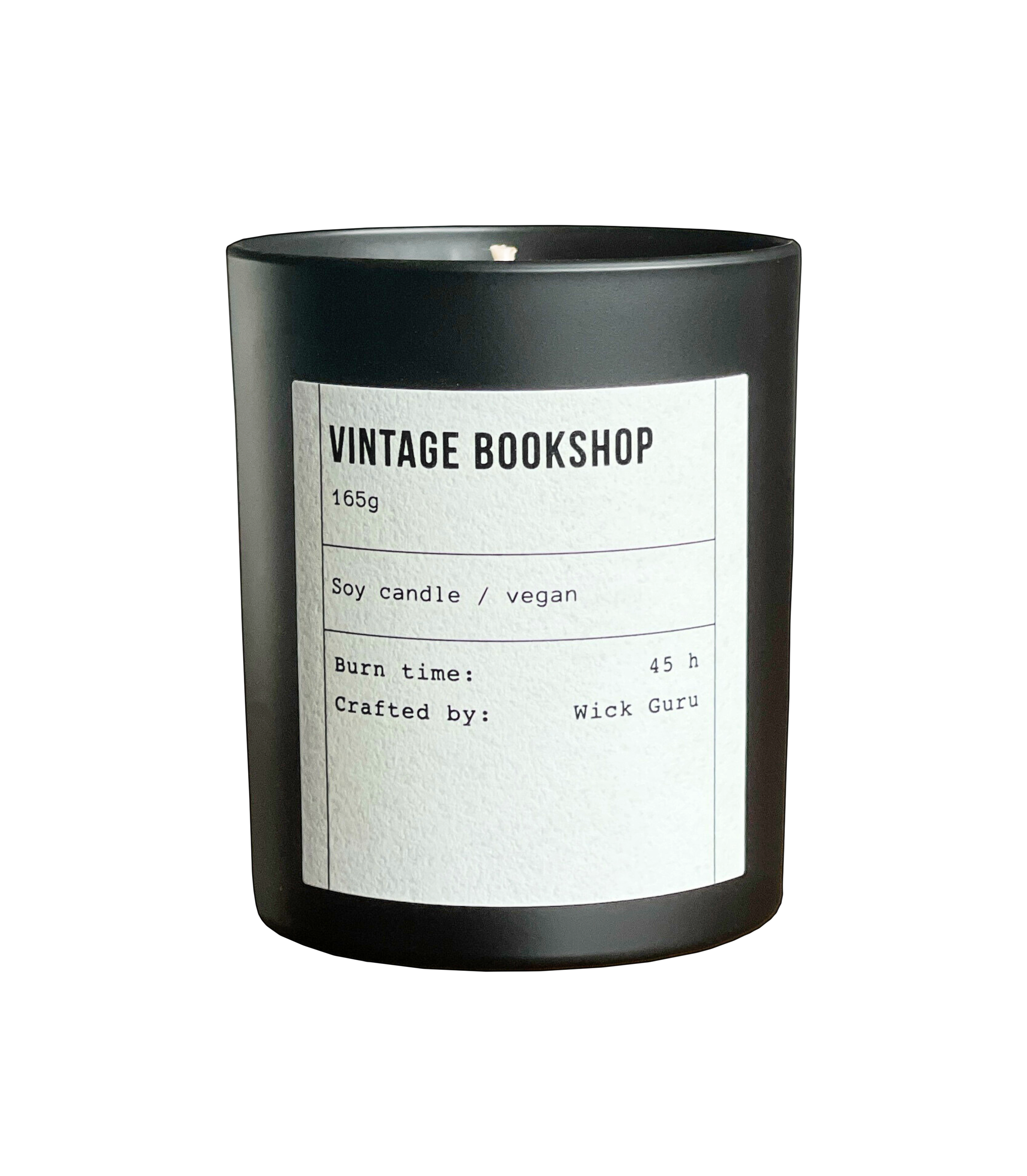 Black candle with a white label on a white background