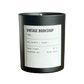Black candle with a white label on a white background