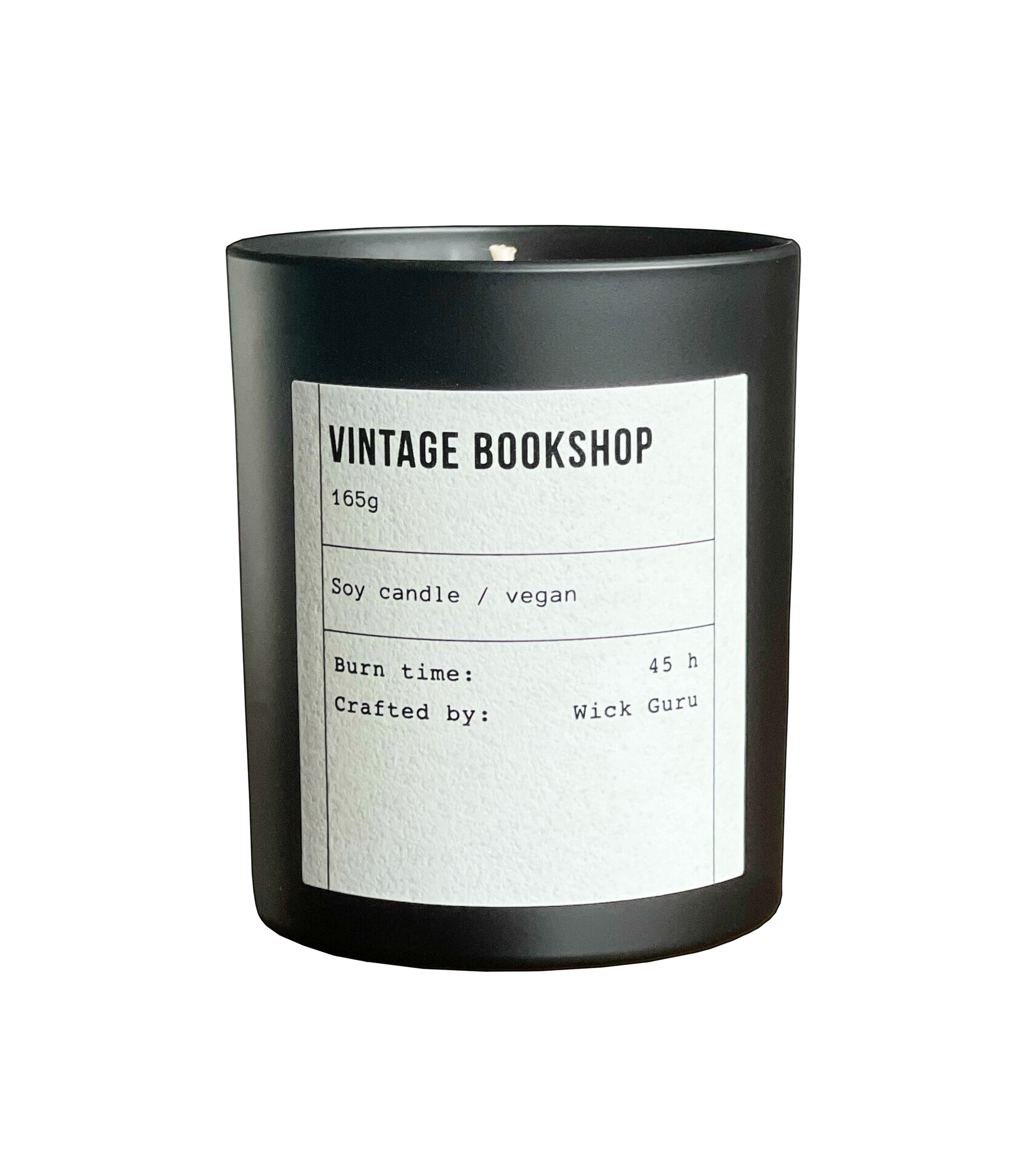 Black candle with a white label on a white background