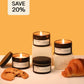 Candles with packaging on a white surface against an orange background, with a 'Save 20%' label.