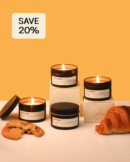 Candles with packaging on a white surface against an orange background, with a 'Save 20%' label.