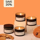 Candle jars with visible labels on a white surface against an orange background, with a 'SAVE 20%' label.