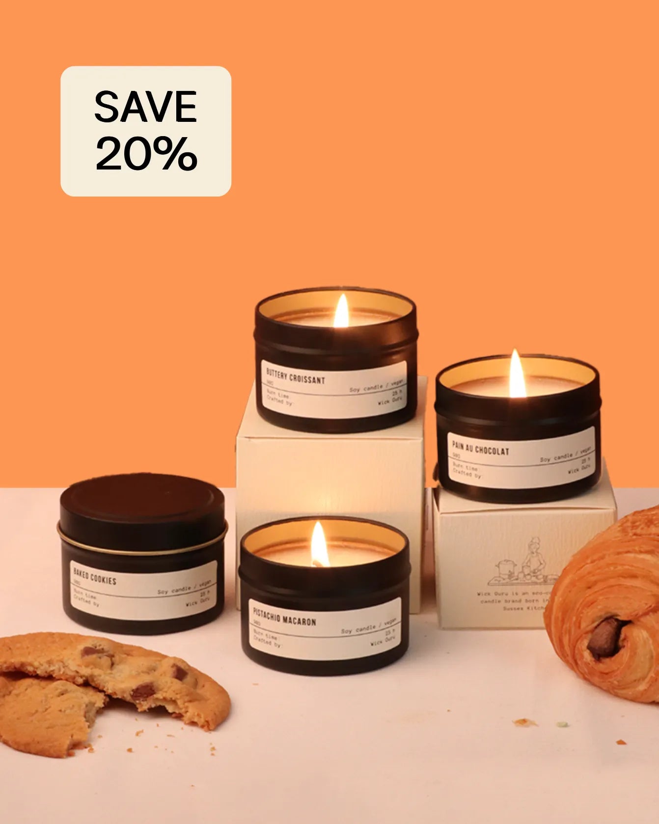 Candle jars with visible labels on a white surface against an orange background, with a 'SAVE 20%' label.