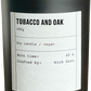 Candle with 'Tobacco and Oak' label on a white background